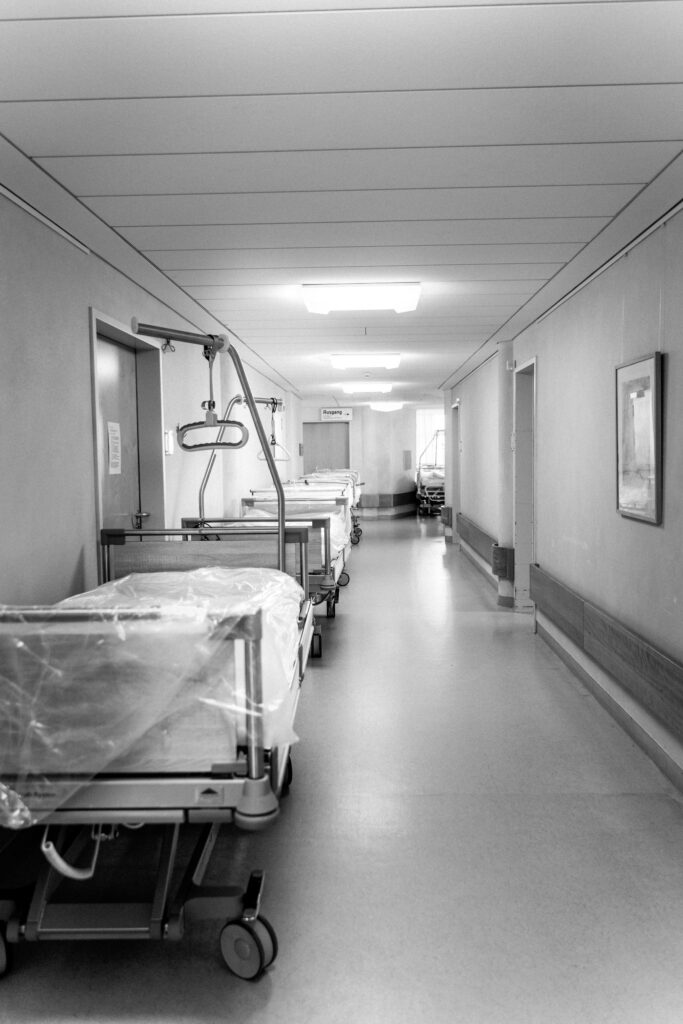 Empty stretchers in a hospital hallway